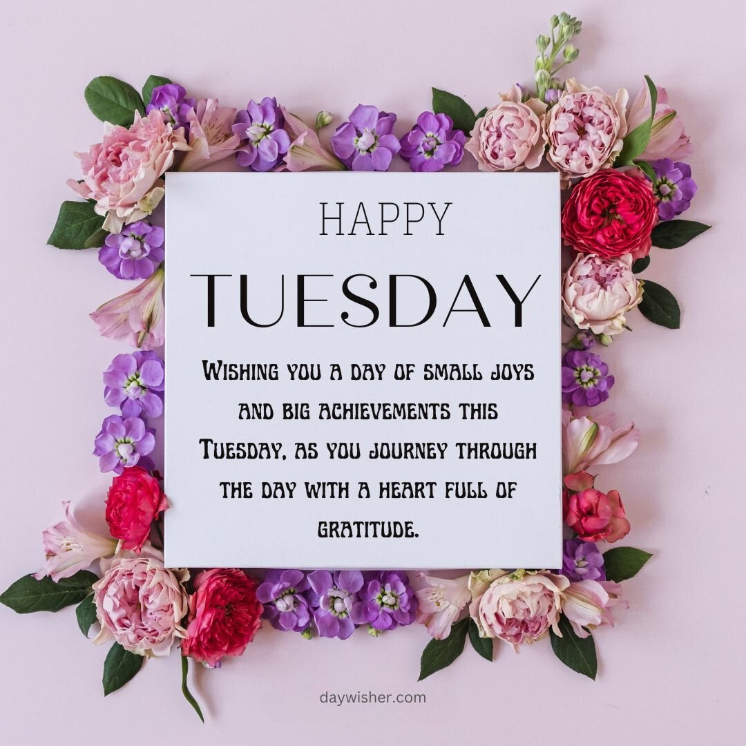 A decorative image featuring a message "Happy Tuesday Blessings" surrounded by a beautiful floral arrangement of pink and purple flowers against a pink background.