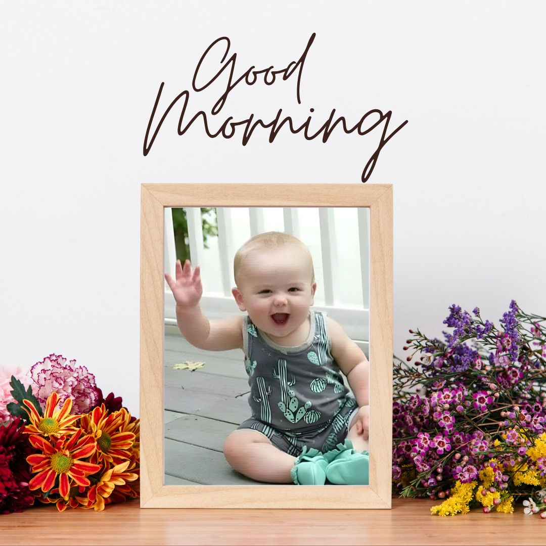 Cheerful baby sitting on a wooden deck, waving happily, surrounded by vibrant flowers, capturing a joyful and welcoming good morning baby greeting.