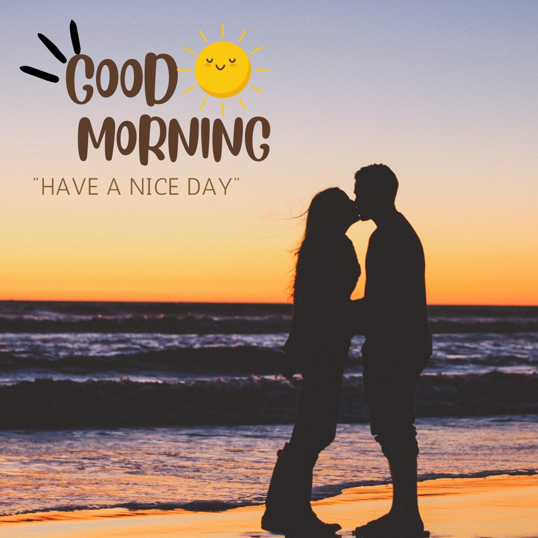 A silhouette of a couple sharing a kiss at the beach during sunrise. The sky is painted with vibrant hues of orange and purple as the sun rises over the horizon. The text "Good Morning" is written in a playful brown font with a smiling sun icon, followed by "HAVE A NICE DAY" in smaller letters. The scene captures a peaceful and romantic moment by the ocean.