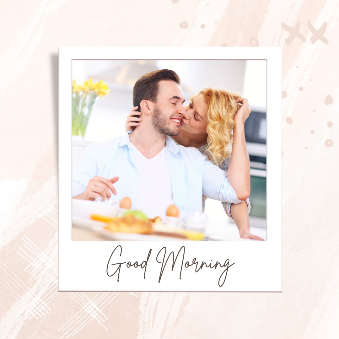 A couple enjoying breakfast at home. The woman is kissing the smiling man on the cheek while they sit at the table with breakfast items. The man is wearing a light blue shirt, and the woman has blonde hair. The image has a white border with "Good Morning" written in a cursive font at the bottom.