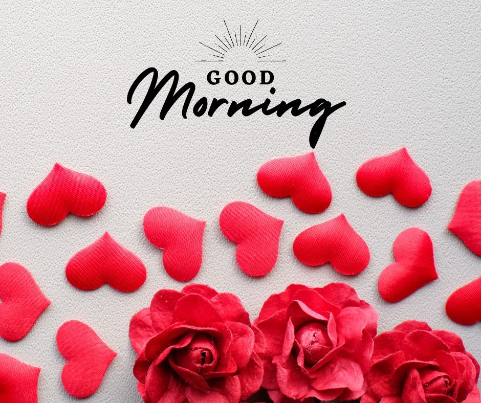 Close-up of a "Good Morning" greeting card adorned with vibrant red rose blossoms and scattered heart shapes on a textured beige background, perfectly embodying a warm and loving morning message.
