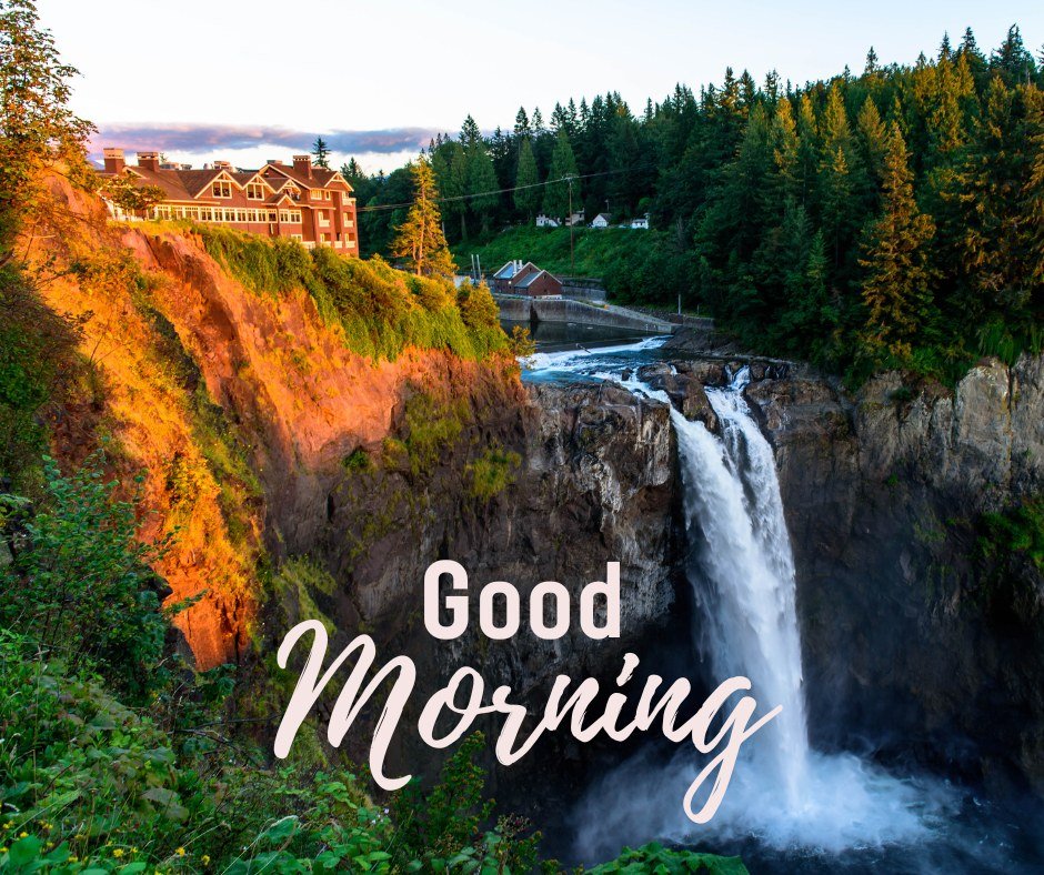 A stunning good morning image showcasing a powerful waterfall cascading down a rocky cliff surrounded by lush greenery. A charming building sits atop the cliff, bathed in the golden light of the morning sun. The text "Good Morning" is elegantly written in the foreground. This image captures the beauty and majesty of nature, making it perfect for an invigorating and picturesque morning greeting.