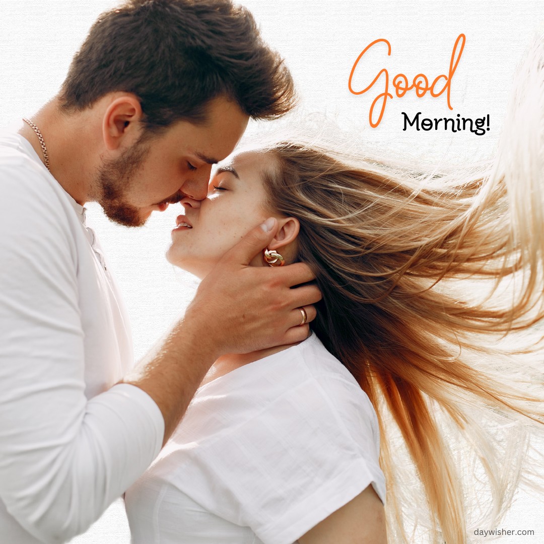 A romantic morning kiss between a couple, with the man's hand gently holding the woman's face, as her hair flows in the wind, accompanied by the text "Good Morning!" Ideal for conveying love and warmth.