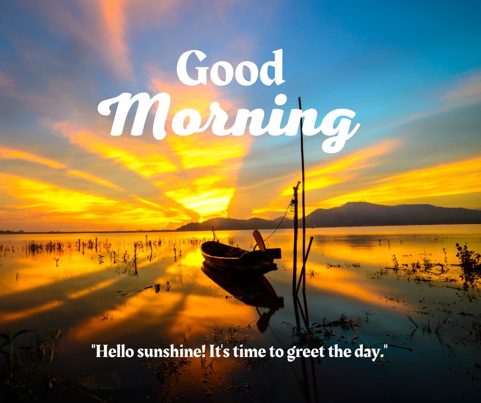 A serene sunrise over a calm lake with a small boat anchored near the shore. The sky is painted with vibrant shades of orange, yellow, and blue as the sun rises, casting reflections on the water. The text "Good Morning" is displayed prominently, along with the quote "Hello sunshine! It's time to greet the day." This beautiful scene captures the essence of a good morning with natural sunshine, perfect for sharing positive and inspiring vibes.