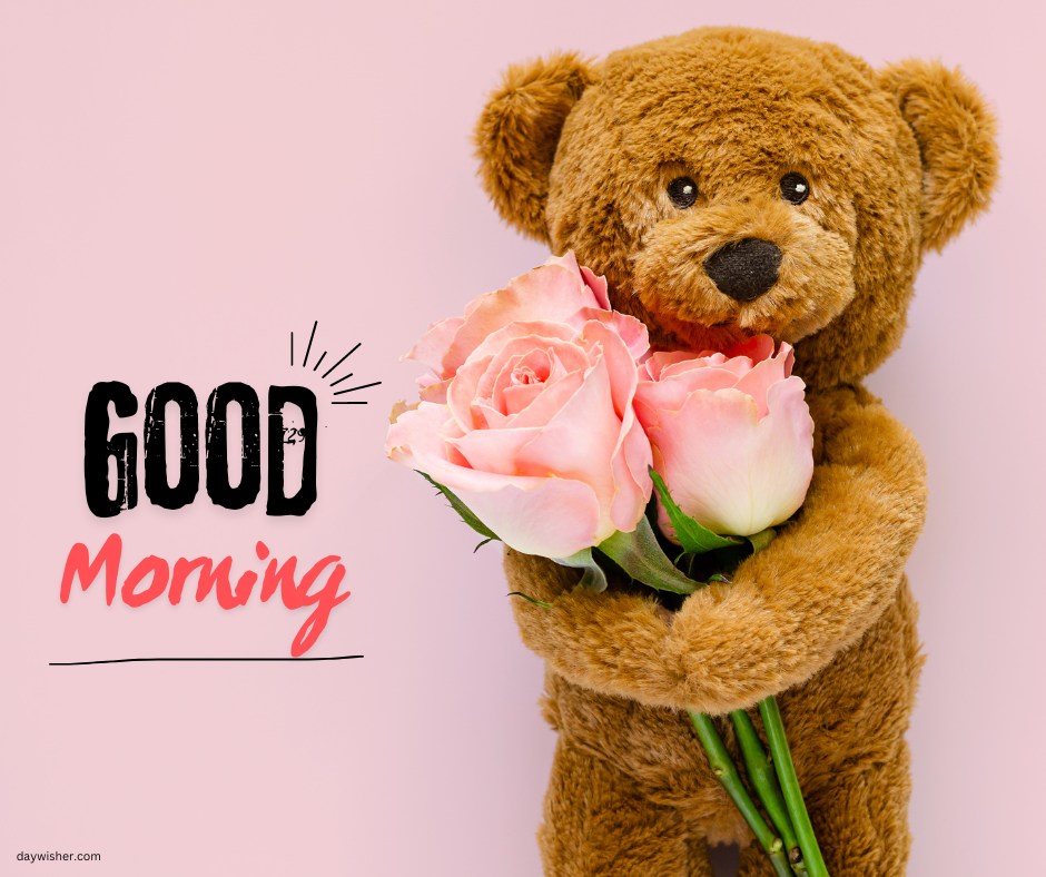 A cute good morning teddy bear holding a bouquet of pink roses against a light pink background. The image features the text "Good Morning" in bold letters.