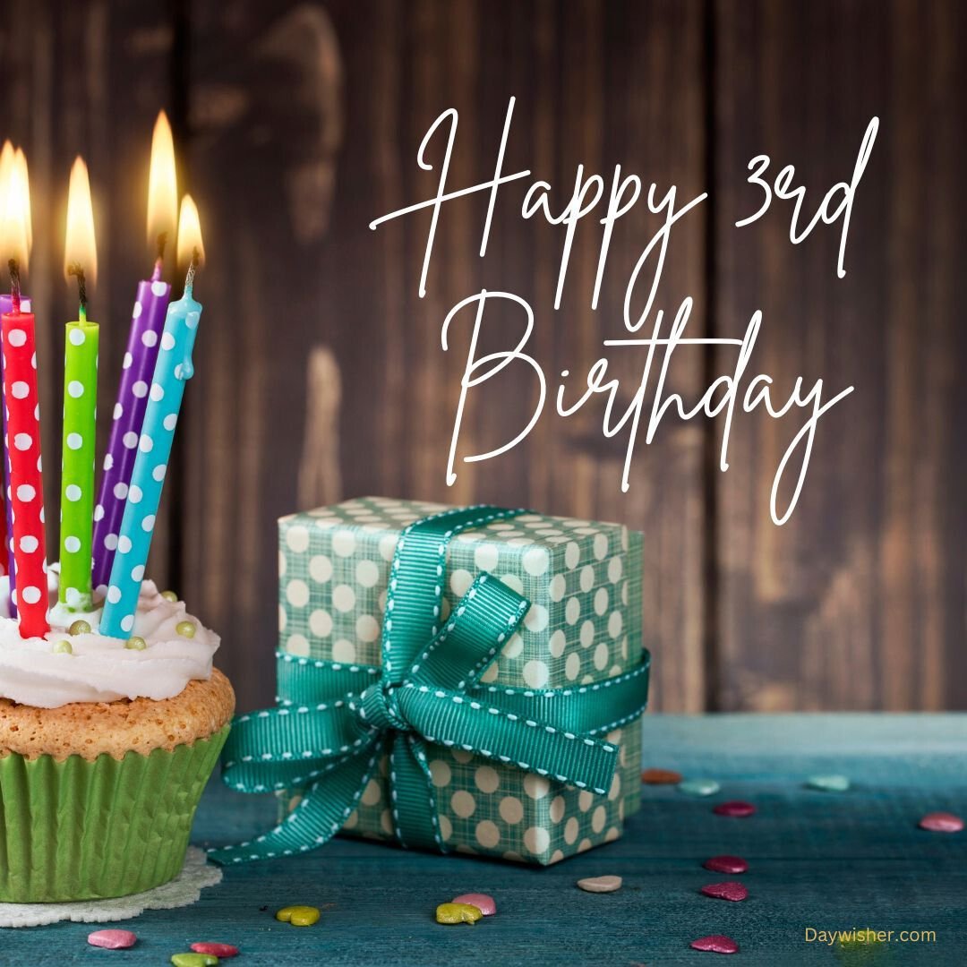 A celebratory image featuring a cupcake with lit candles and a green polka-dotted gift box next to it. The text reads "Happy 3rd Birthday." Colorful confetti is scattered
