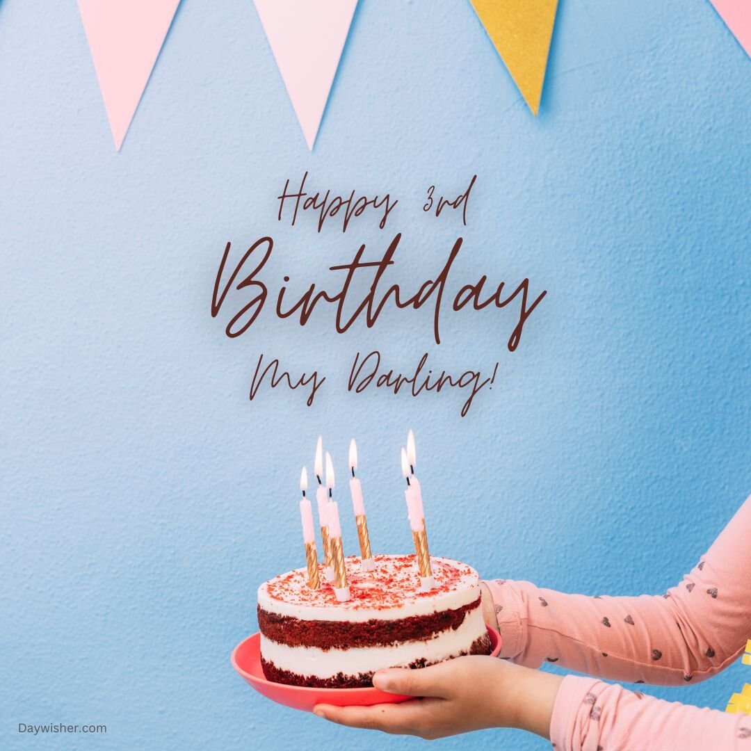 A person holding a red velvet cake with three lit candles and "happy 3rd birthday my darling" written in script, against a blue background with colorful bunting, perfect for birthday images.