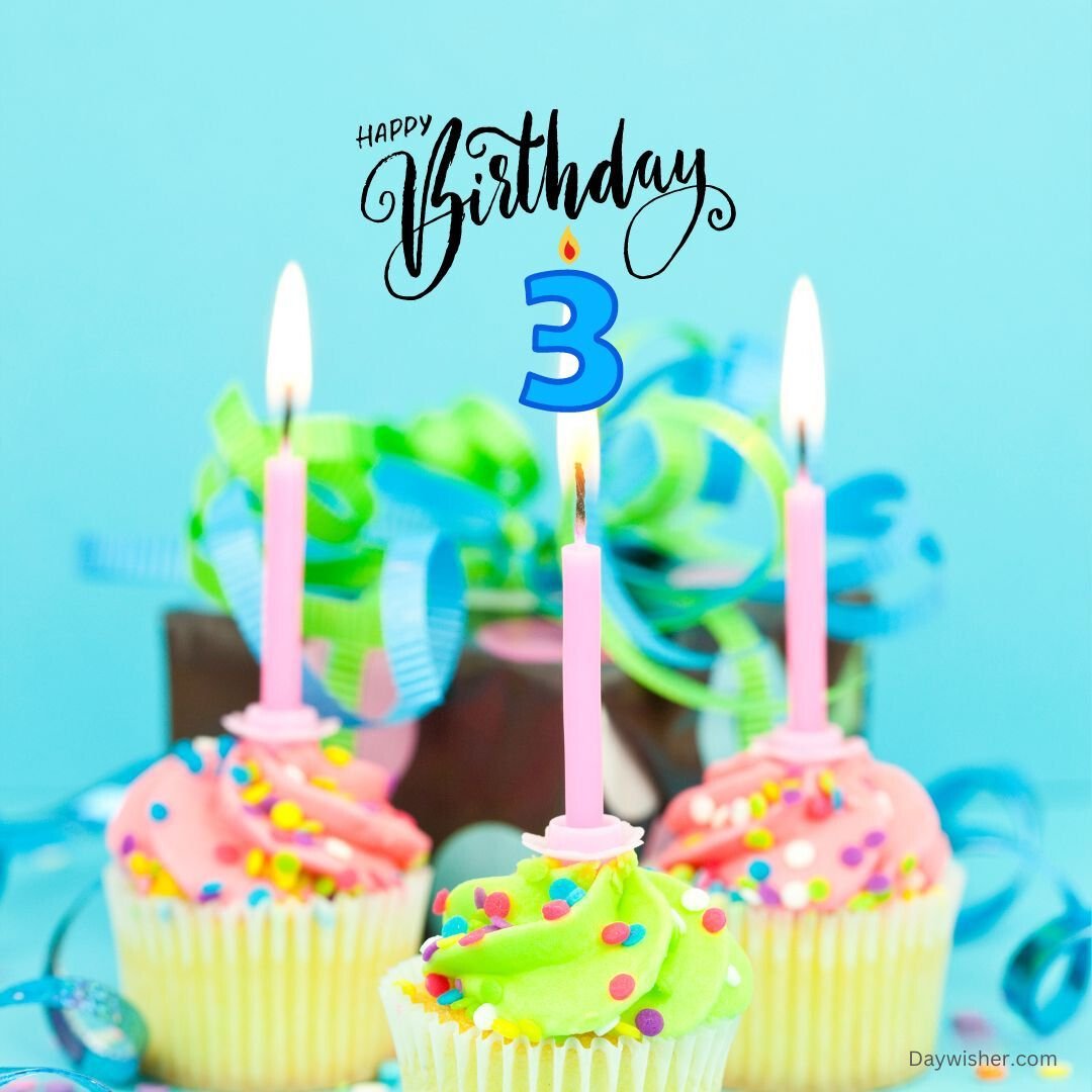 Three colorful cupcakes with pink and green frosting, decorated with sprinkles and topped with lit candles, celebrate a happy 3rd birthday against a blue background.