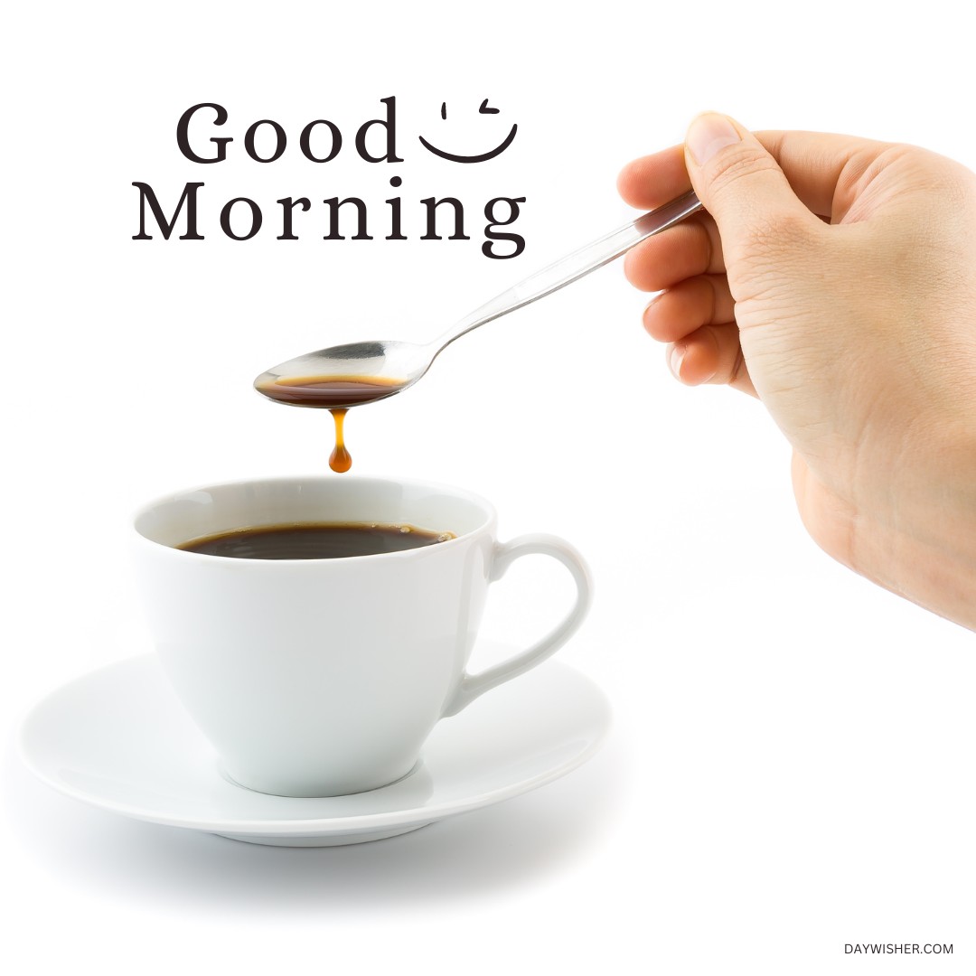 A clean and inviting image of a white coffee cup on a saucer, with a spoon dripping fresh coffee back into the cup. The simple "Good Morning" text above enhances this moment, perfect for those searching for good morning coffee images that capture the essence of a peaceful and refreshing start to the day.