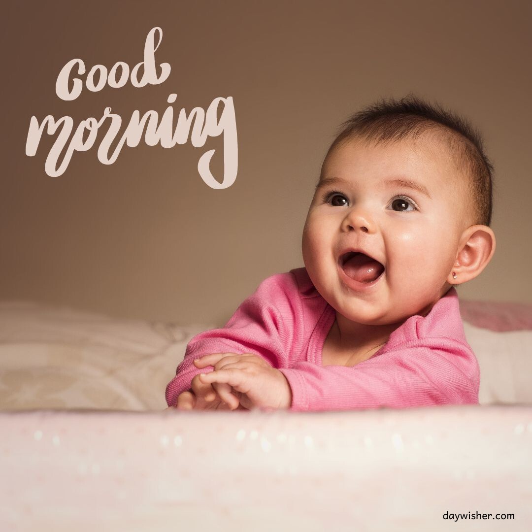 Joyful baby girl in pink smiling widely, under a delicate 'Good Morning' script, ideal for a delightful good morning baby image.