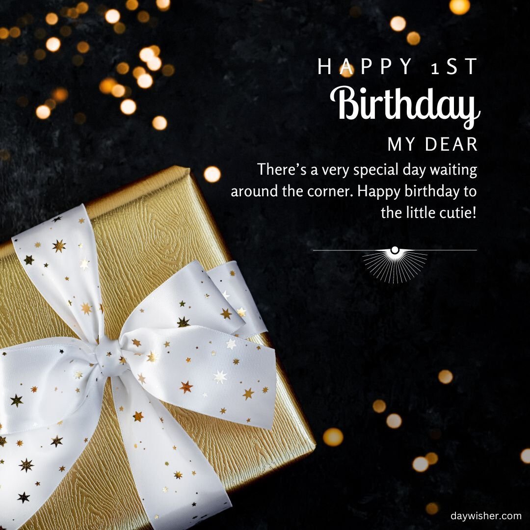 A birthday greeting card with the text "happy 1st birthday my dear" on a dark background, featuring a gold-bordered gift box adorned with a white bow and star-shaped confetti.