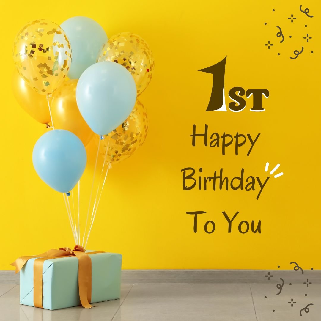 Yellow wall with "Happy 1st birthday to you" in black text, decorated with blue and gold balloons and a wrapped gift box on a white floor.