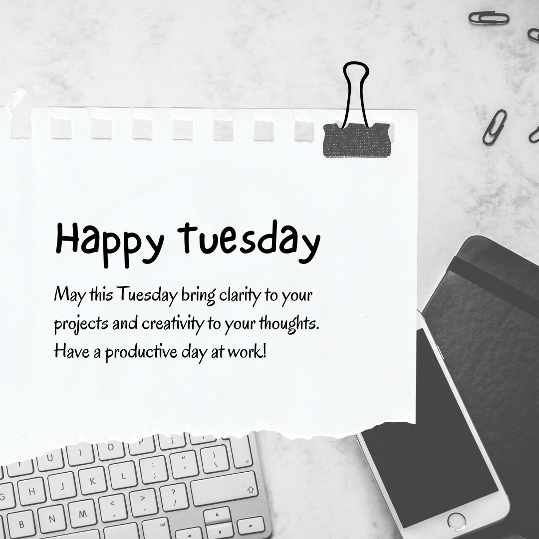 Office-themed Happy Tuesday image featuring a snippet of paper pinned by a black binder clip, a keyboard, and a smartphone on a marble surface. The note wishes clarity and creativity for a productive day at work, aligning with Tuesday Morning Wishes to Do Great at Work.