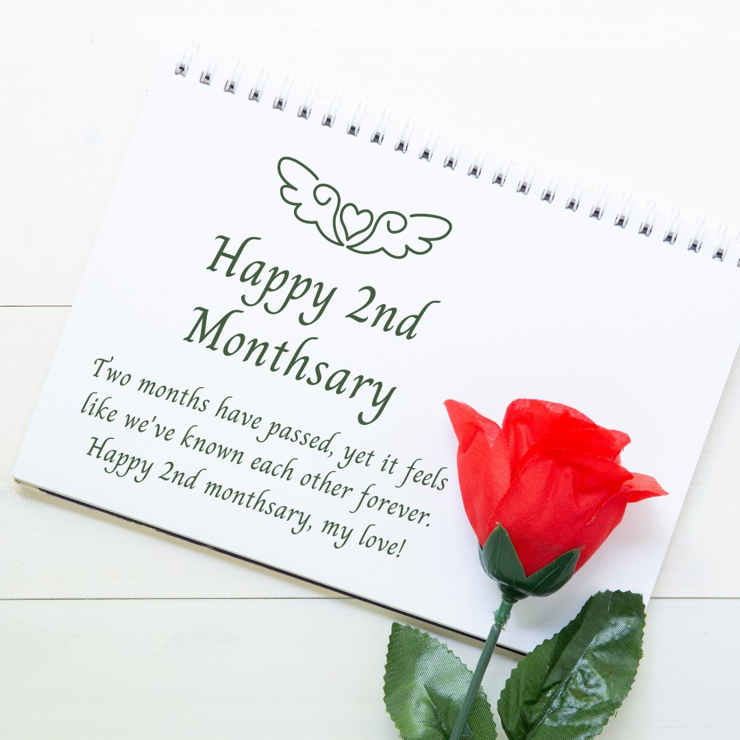 2nd Monthsary message for boyfriend displayed on a spiral notebook with a red rose, featuring the message 'Two months have passed, yet it feels like we’ve known each other forever. Happy 2nd monthsary, my love!' and a heart with wings illustration.