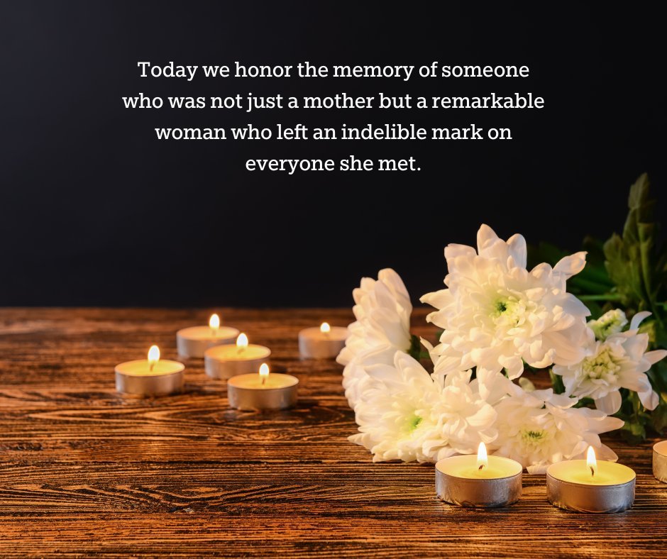 Lit candles with white chrysanthemums on a wooden table, accompanied by a message honoring the death anniversary of a loved one’s mother