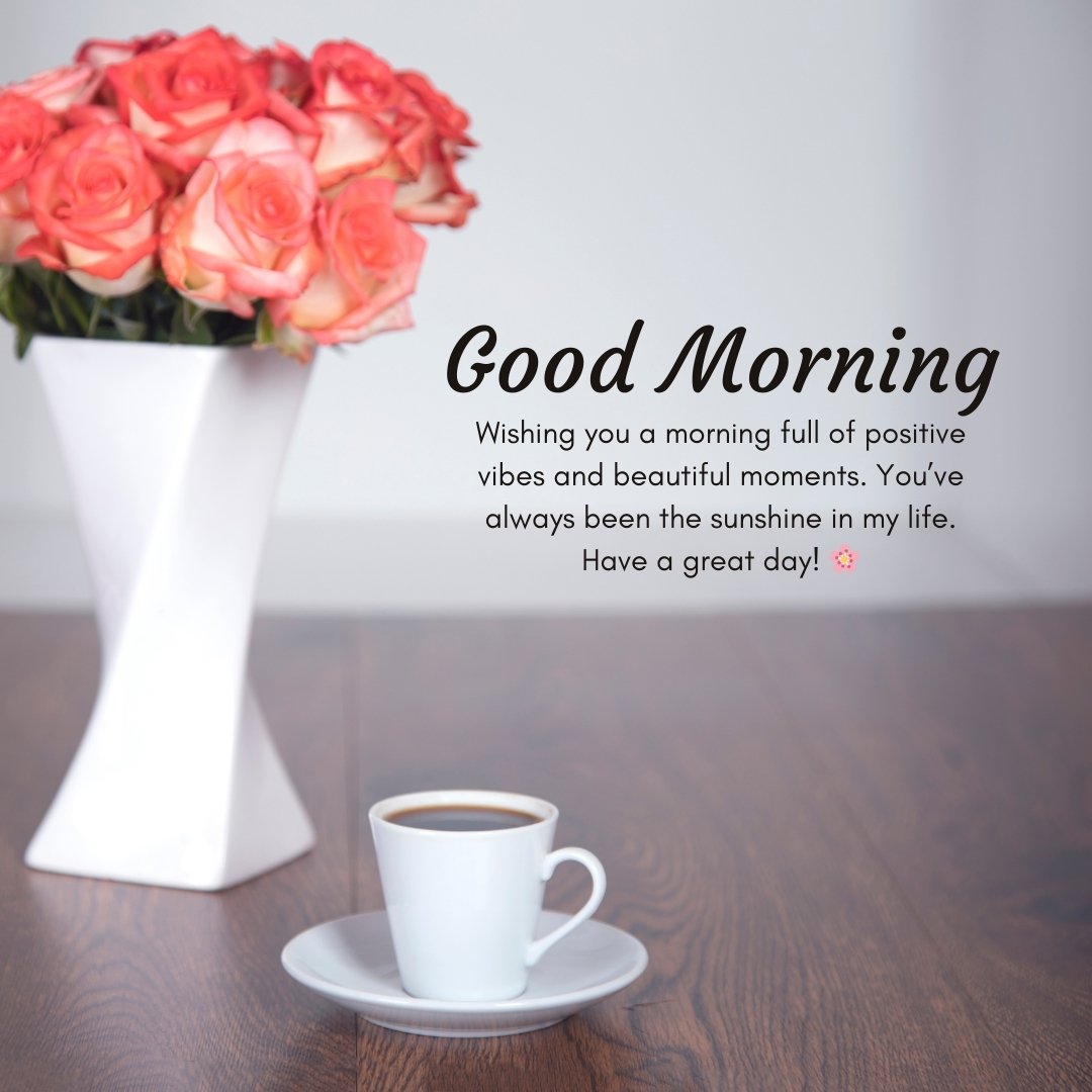 Good Morning Beautiful Messages for Friend with a vase of pink roses and a cup of coffee on a wooden table, creating a warm and positive morning atmosphere.